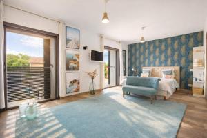 a bedroom with a bed and a couch and a tv at Grande Maison familiale - Piscine privée & Jardin clos - 10min Avignon & Château-neuf-du-Pape - Climatisation - Parking privé gratuit - Animaux admis in Sorgues