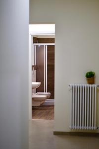 a bathroom with a toilet and a radiator at Ètoile Palace Gravina in Gravina in Puglia +114 photos