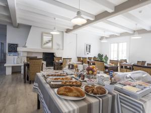 a buffet of food on a table in a room at Hotel Autre Mer in Noirmoutier-en-l'lle