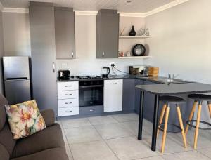 a kitchen with a table and a counter top at 17 On Sleigh in Langebaan
