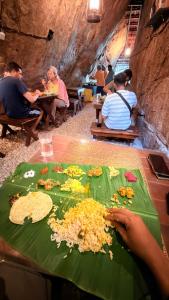 a group of people sitting at a table eating food at Qatsyir Horizon in Varagampadi +141 photos