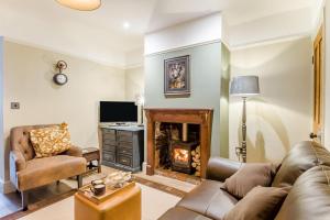 a living room with a couch and a fireplace at 2 Bed in Pakefield oc-p32922 in Lowestoft