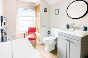 a bathroom with a sink and a toilet and a mirror at 2 Bed in Pakefield oc-p32922 in Lowestoft +13 photos