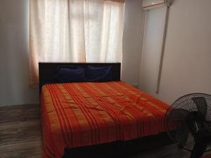 a bedroom with a bed in front of a window at Quiet corner ideal for holidays in Centre de Flacq