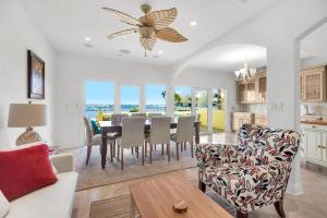 a dining room and living room with a table and chairs at Buena Vida 23 in Navarre