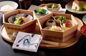two boxes of food on a table with rice at Imperial Hotel, Kyoto in Kyoto