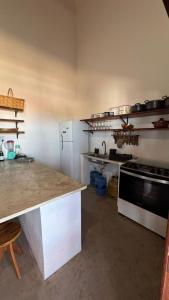 a kitchen with a counter and a stove top oven at Casa Dunas Baleia in Itapipoca