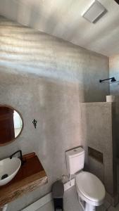 a bathroom with a white toilet and a sink at Casa Dunas Baleia in Itapipoca +9 photos