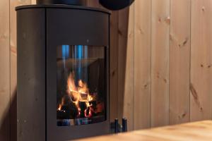 a fireplace with a fire inside of it at TT28- Ski-in out apartment in Trysil turistcenter with sauna in Trysil