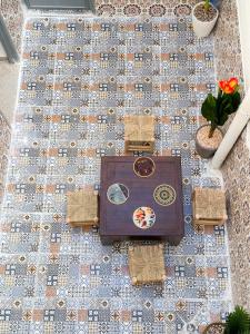 an overhead view of a table and chairs on a tile floor at Dar Baba Hassan - Ocean View & Ensuite in Taghazout +18 photos