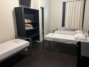 a room with two beds and a closet at Hotel SP Centro by Rede Único in São Paulo