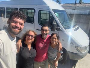 a group of people standing in front of a van at Alojamiento MI MOMMA in Osorno