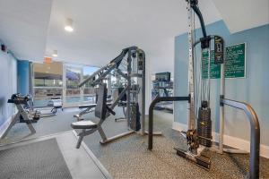 a gym with treadmills and machines in a building at Pelican Beach 1216 - Ocean Front Condo with Shared Pool & Beach Access in Destin