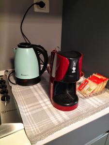two coffee pots sitting on top of a counter at La Quiete appartamento in campagna a Spoleto in Spoleto
