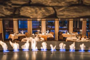 a view of a restaurant with tables and chairs at La Val Hotel & Spa in Breil/Brigels