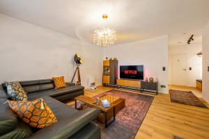 a living room with a couch and a tv at Diamond Deluxe in Ludwigshafen am Rhein