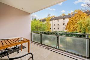 a balcony with a table and chairs and a view at Diamond Deluxe in Ludwigshafen am Rhein