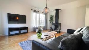 a living room with a couch and a table at Lägenhet - Karlskoga folkhögskola in Karlskoga