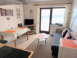 a living room with a couch and a table at Ferienwohnung Haus Weitblick in Medebach