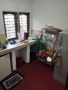 a kitchen with a desk and a refrigerator and a counter at Dad's Inn by Wee Group in Andiambalama