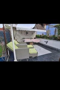 a patio with chairs and a table and a bench at Schnuckelchen in Marl 2 in Marl