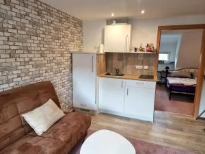 a living room with a couch and a kitchen at Schnuckelchen in Marl 2 in Marl