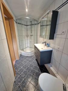 a bathroom with a toilet and a sink and a mirror at Schnuckelchen in Marl 2 in Marl