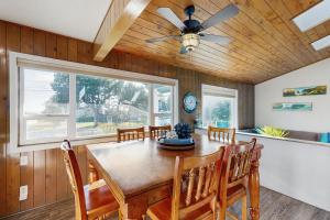a dining room with a table and a ceiling fan at Ocean View Retreat in Brookings