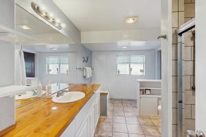 a white bathroom with a sink and a mirror at Ocean View Retreat in Brookings +16 photos