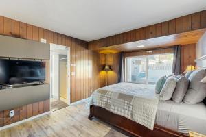 a bedroom with a large bed and a large window at Ocean View Retreat in Brookings