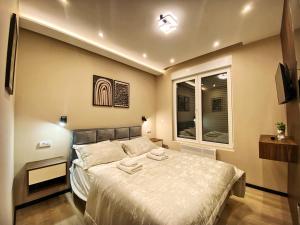 a bedroom with a large bed and a window at Beli Bregovi Lux in Zlatibor