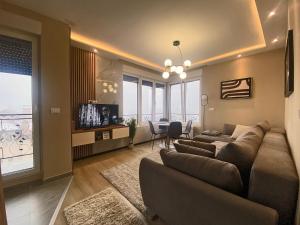 a living room with a couch and a table at Beli Bregovi Lux in Zlatibor