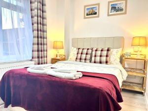 a bedroom with a bed with a red blanket at Victory Gate 3 double bed House in Old Portsmouth Parking Pets in Portsmouth