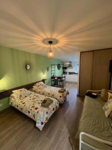 a living room with two beds and a couch at L'éscale étape in Lagney