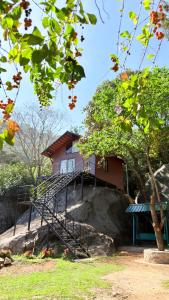 a house on top of a rock with a staircase at Qatsyir Horizon in Varagampadi