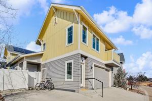 a yellow and white house with bikes parked in front at The Revive Loft with Balcony, Workspace and Bikes in Fort Collins