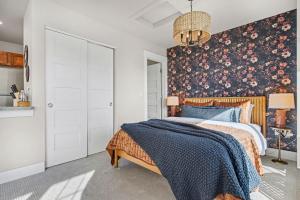 a bedroom with a bed with a floral wallpaper at The Revive Loft with Balcony, Workspace and Bikes in Fort Collins