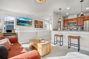 a living room with a couch and a kitchen at The Revive Loft with Balcony, Workspace and Bikes in Fort Collins