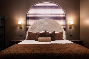 a bedroom with a large bed with a large window at Hollyhock Suite 412 in Louisville