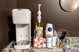a bottle of wine sitting on a counter next to a mixer at Hollyhock Suite 412 in Louisville