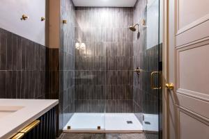a bathroom with a shower with a glass door at Hollyhock Suite 412 in Louisville