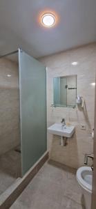 a bathroom with a sink and a mirror and a toilet at Kozatskiy Hotel in Kyiv +87 photos