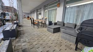 a patio with a couch and chairs and a table at Apartment Local Uetendorf in Uetendorf