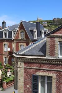 a red brick house with a solar roof at La suite dorée in Étretat