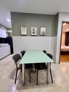 a dining room with a table and chairs at Vortex suites klcc by ARICA in Kuala Lumpur
