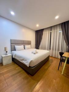 a bedroom with a large bed in a room at Vortex suites klcc by ARICA in Kuala Lumpur