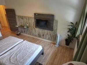 a room with a bed and a tv on a wall at Meyerhof Heiligenrode in Stuhr +86 photos