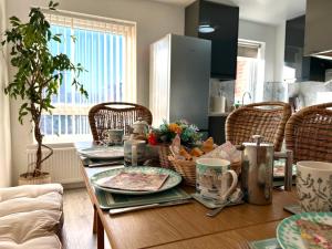 a dining room table with plates and cups on it at Victory Gate 3 double bed House in Old Portsmouth Parking Pets in Portsmouth