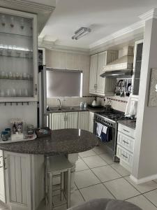 a kitchen with a marble counter top in a kitchen at Sea Breeze in Mossel Bay