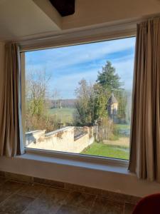 a large window with a view of a yard at Gite du Bois de Lord in Grandham